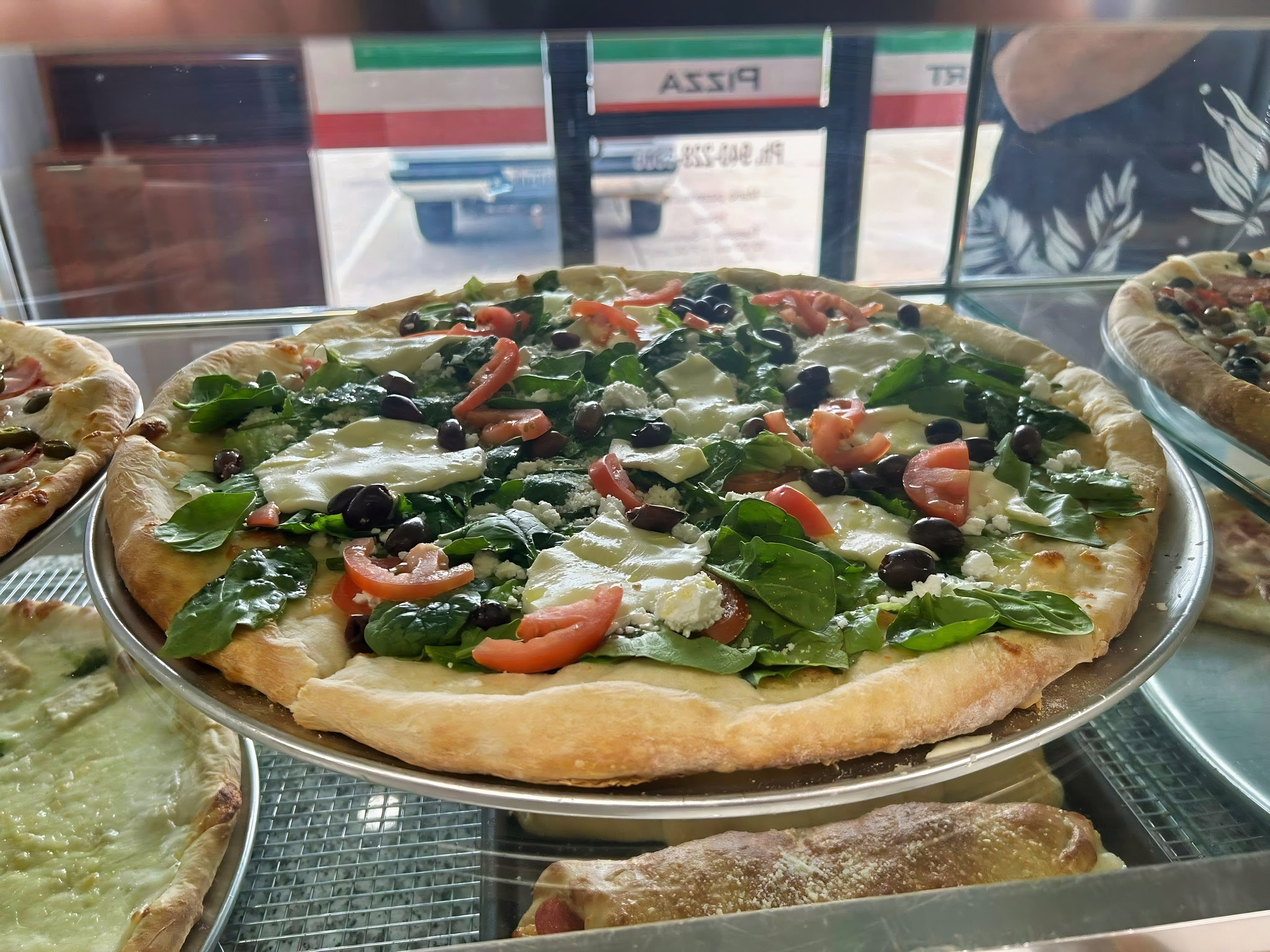 Fresh specialty pizza at Mario's Pizza by the Slice